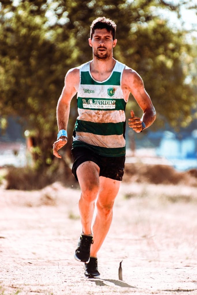 A determined male runner competes in an outdoor race, showcasing endurance and athleticism.